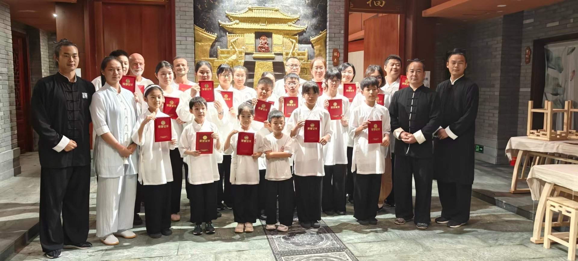 Children receive Wudang graduation certificates with masters