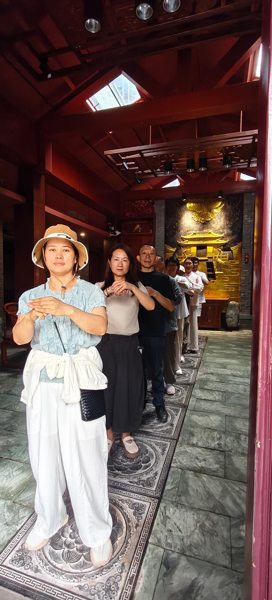 Parents and children practising Tai Chi together in a Wudang hall